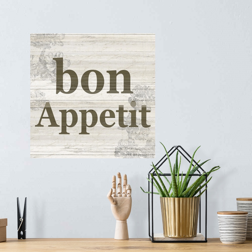A bohemian room featuring The word ?bon appetit? on a wood panel background with a faded floral design.�