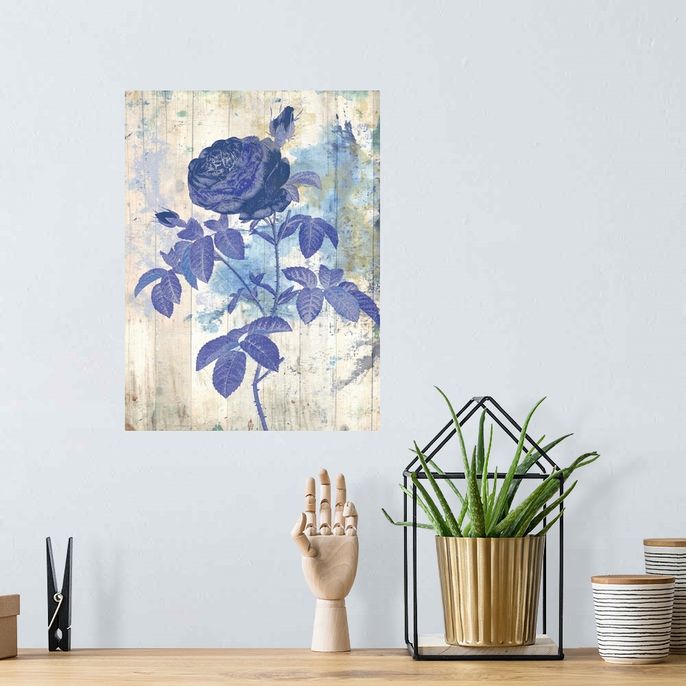 A bohemian room featuring Artwork of a blue flower against a weathered and washed looking background.