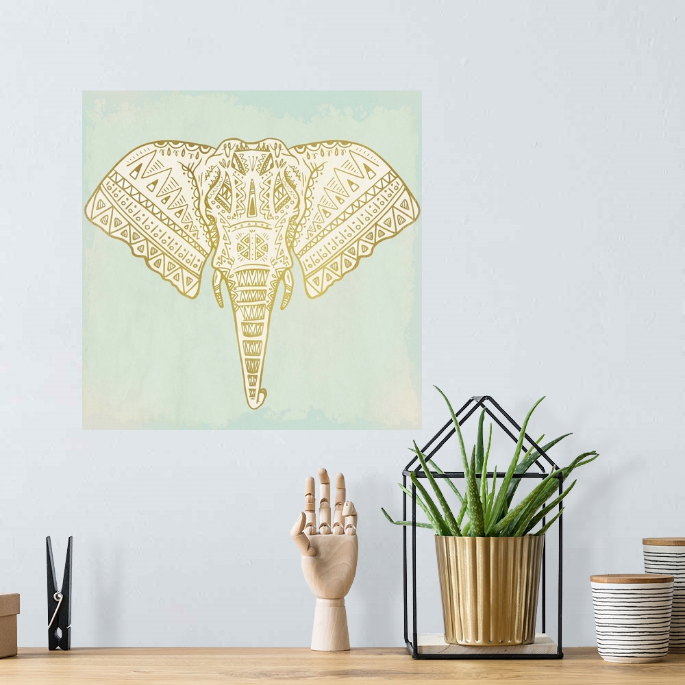 A bohemian room featuring Square art of a uniquely designed metallic gold elephant on a light blue-green painted background.