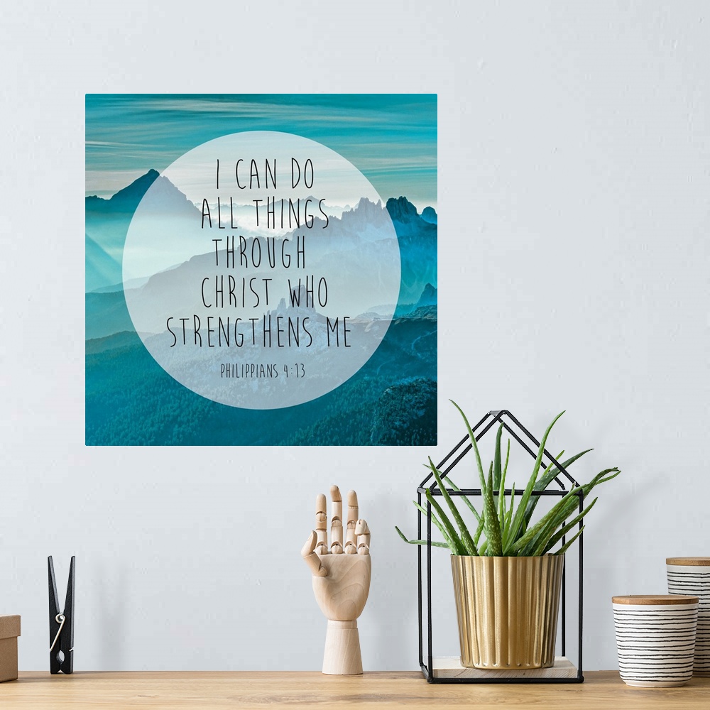 A bohemian room featuring Typography art of a Bible verse over an image of blue, misty mountains.
