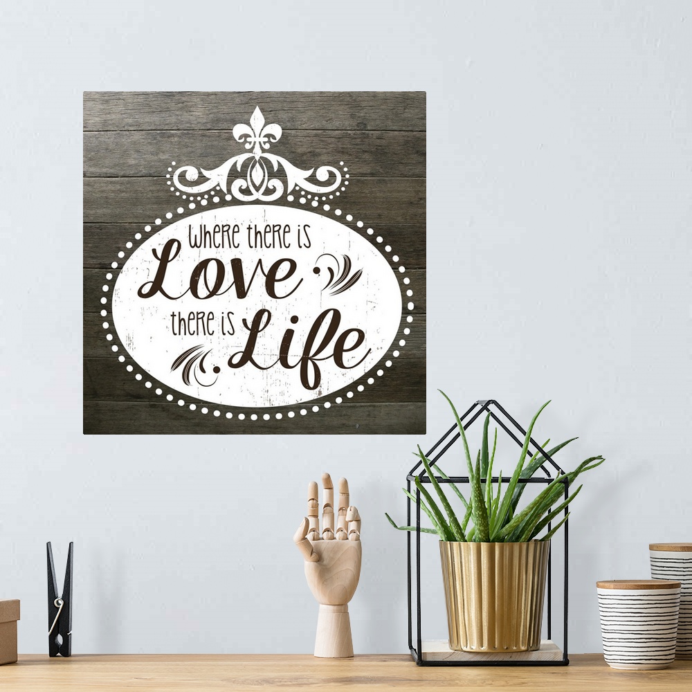 A bohemian room featuring The phrase "Where there is love there is life" on a vintage marquee shape over a faux wood texture.