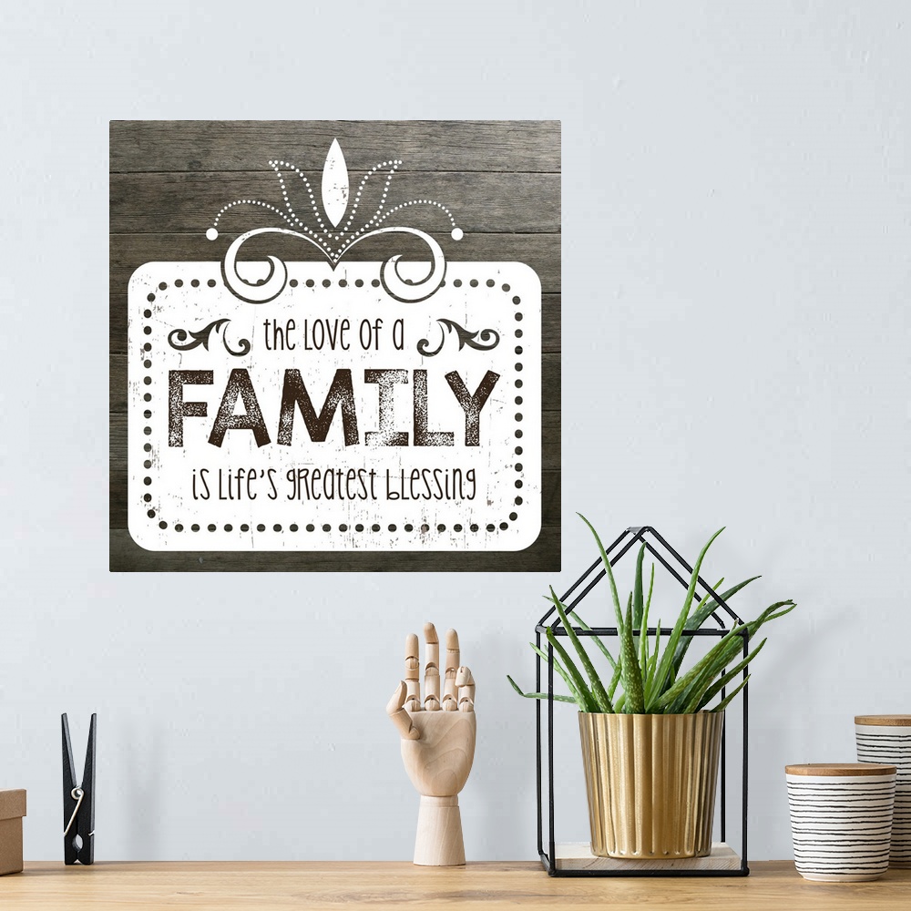 A bohemian room featuring The phrase "The love of a family is life's greatest blessing" on a vintage marquee shape over a f...
