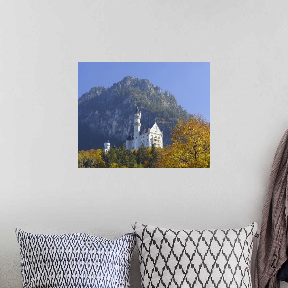 A bohemian room featuring Neuschwanstein Castle above the village of Hohenschwangau in autumn, Bavaria, Germany