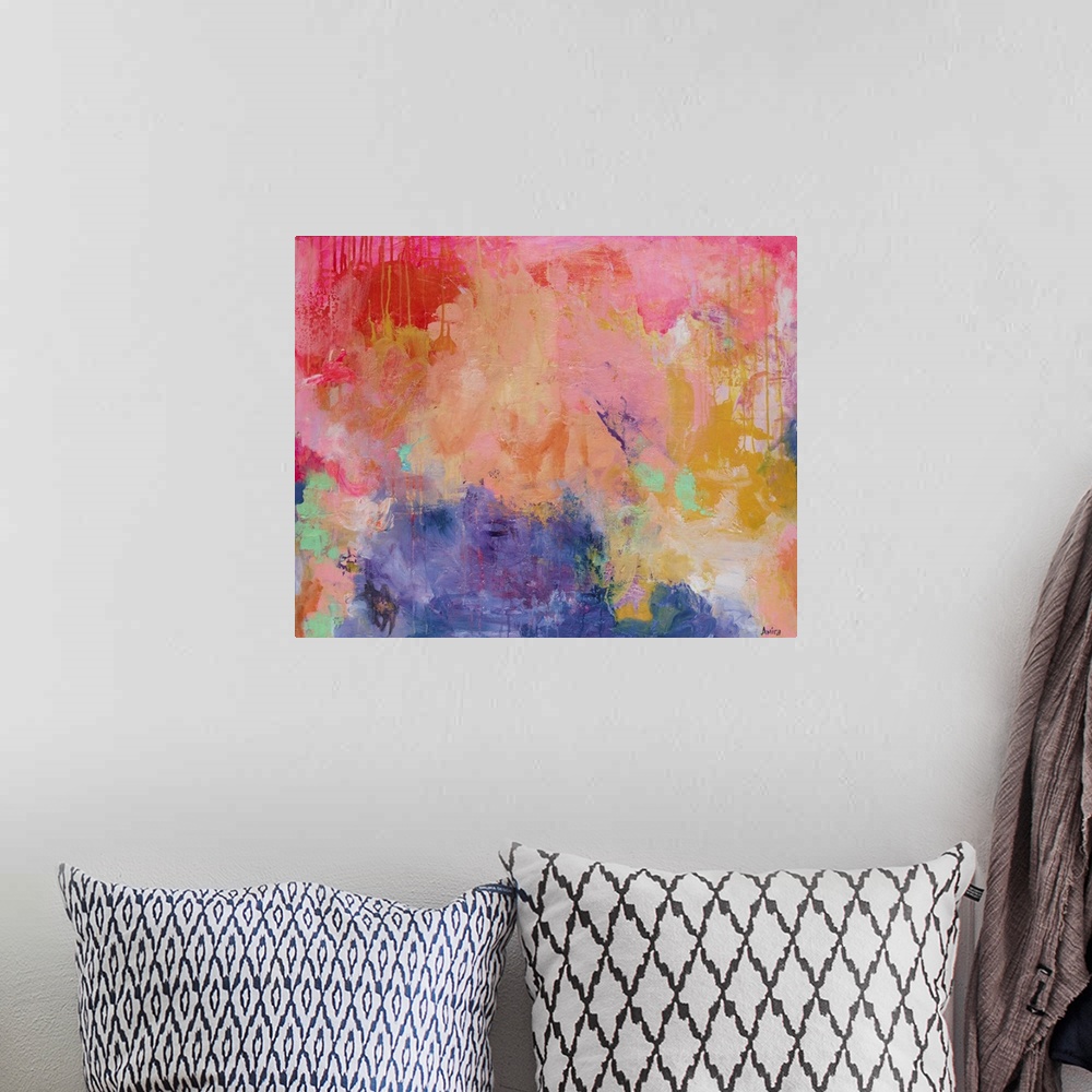 A bohemian room featuring Mixed media contemporary abstract artwork in vibrant shades of pink, orange, and yellow.