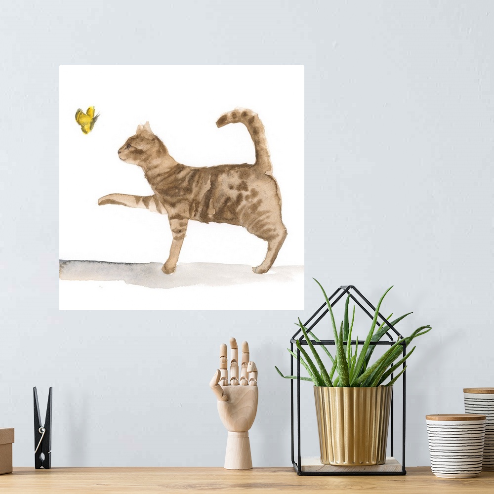 A bohemian room featuring Sweet watercolor painting of a brown tabby cat chasing a butterfly.
