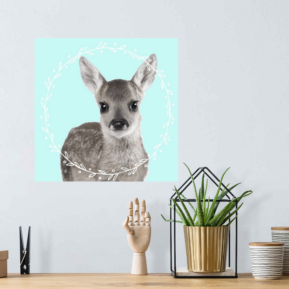 A bohemian room featuring Black and white photograph of a fawn on the middle of a light blue background with an illustrated...