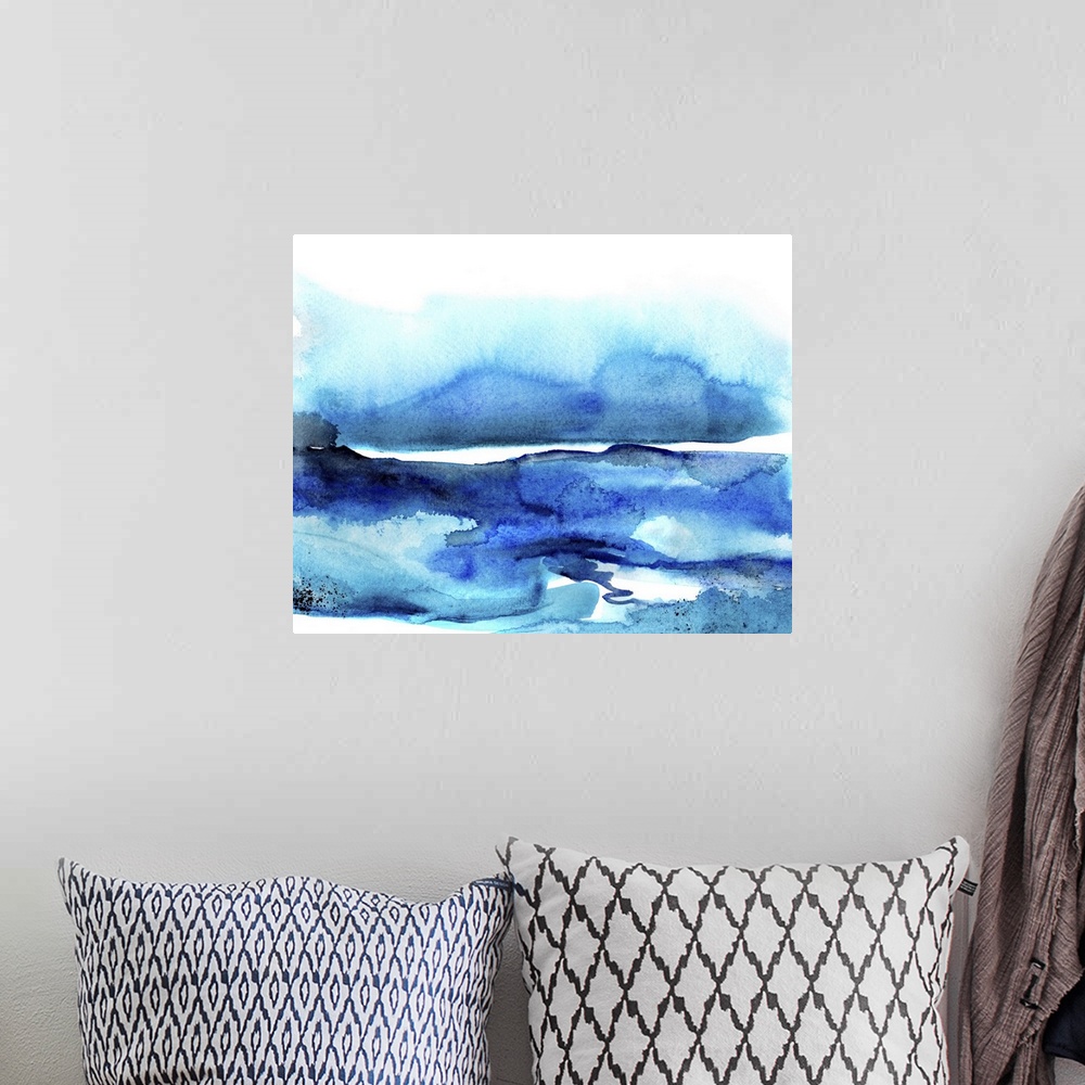 A bohemian room featuring Abstract watercolor artwork of shades of blue blending together.