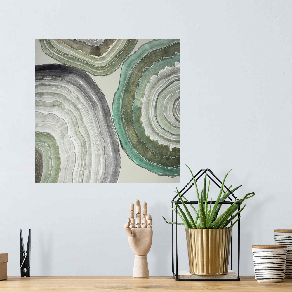 A bohemian room featuring Contemporary home decor artwork of pale colored geode cross sections against a gray background.