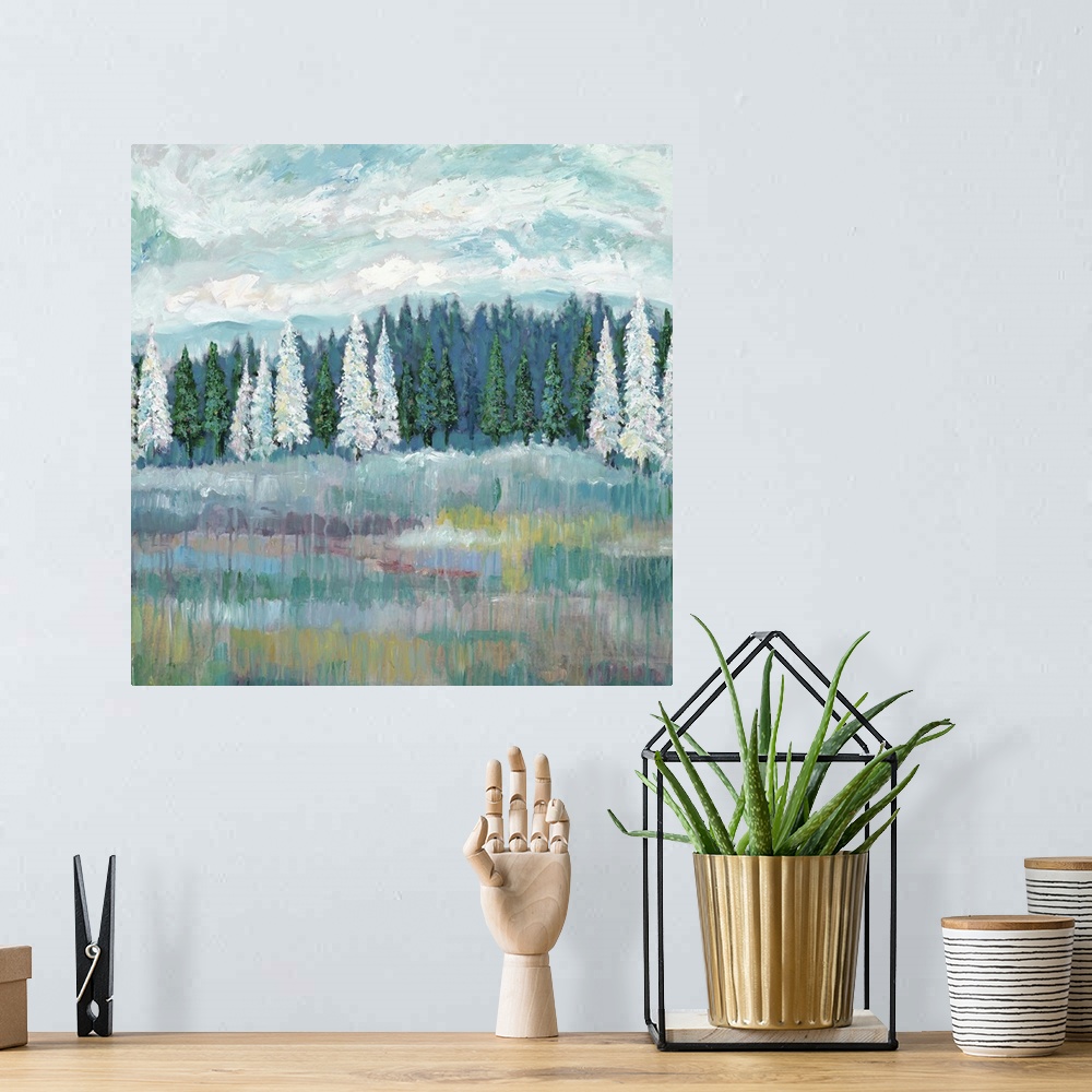 A bohemian room featuring Contemporary artwork of a field with an evergreen forest with white and green trees at the edge.