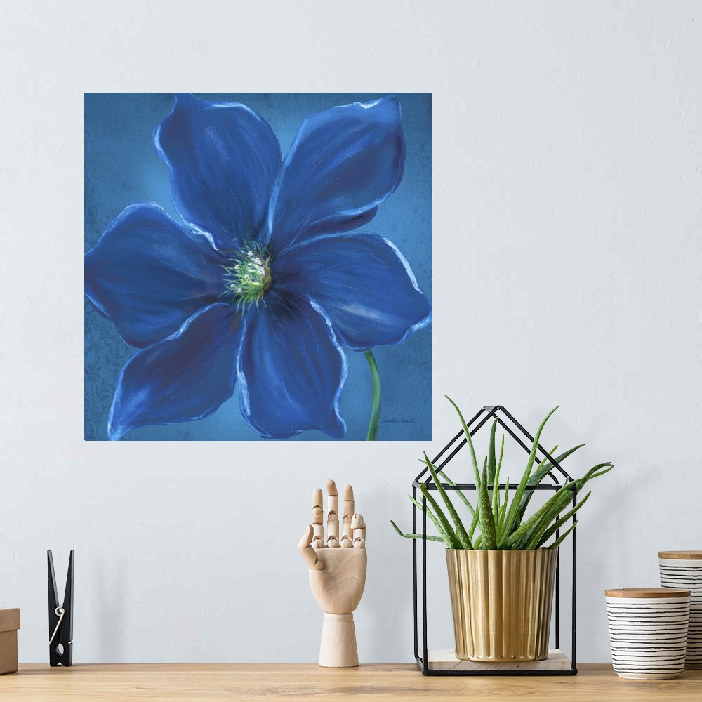 A bohemian room featuring Close up painting of a deep blue flower with wide petals.