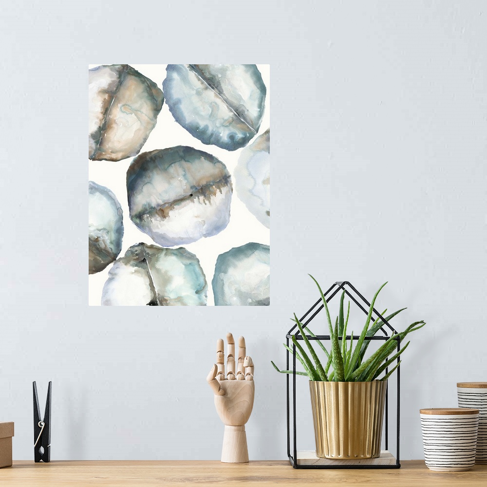 A bohemian room featuring Abstract artwork of organic round shapes in cool tones, resembling smooth rocks.