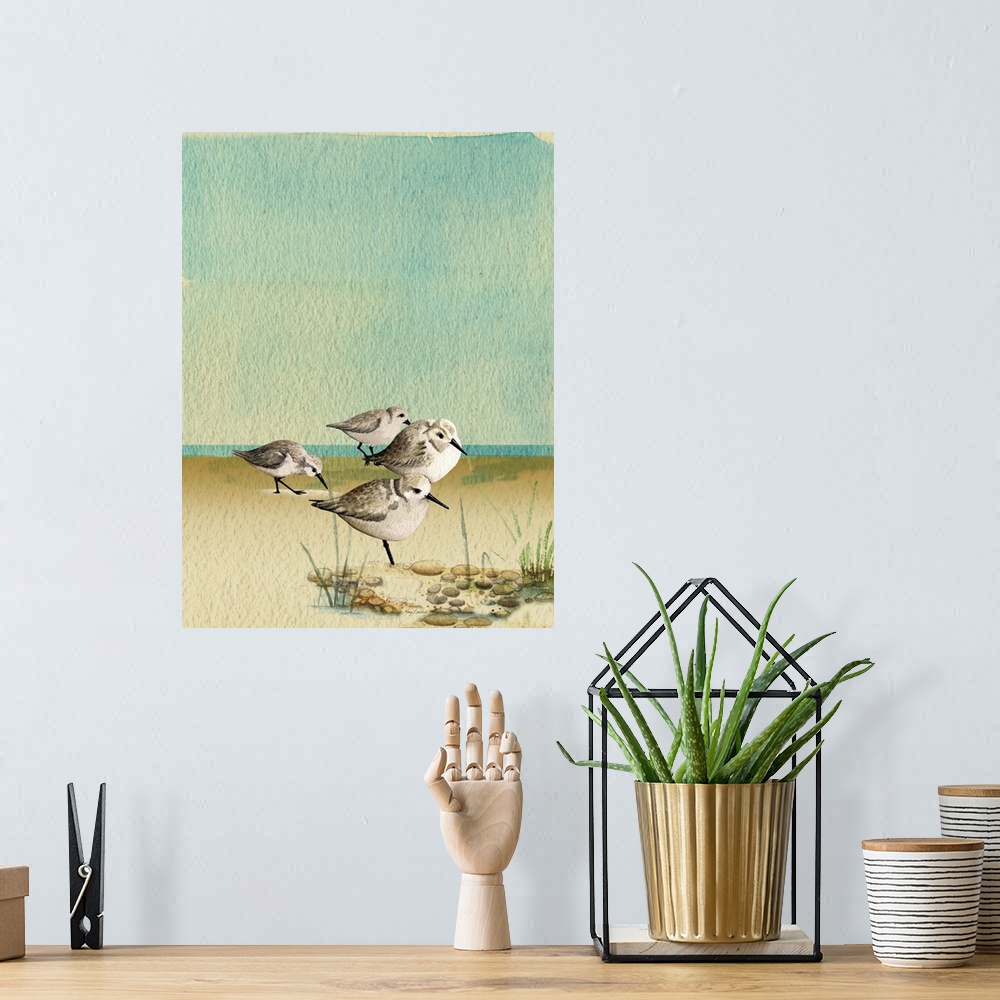 A bohemian room featuring Artwork of a group of sandpipers walking on a sandy beach.