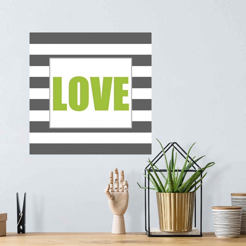 A bohemian room featuring The work Love in green against a dark gray and white striped background.