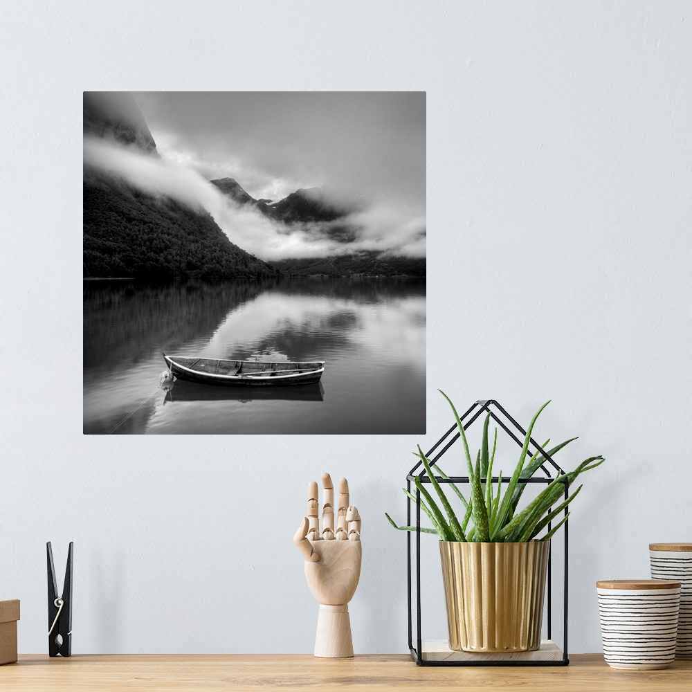 A bohemian room featuring Boat surrounded by foggy mountains
