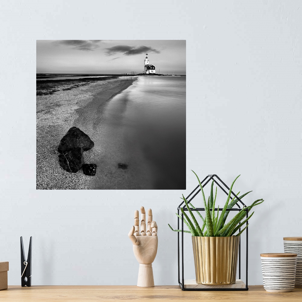 A bohemian room featuring Coastal waters with lighthouse and rocks on shore