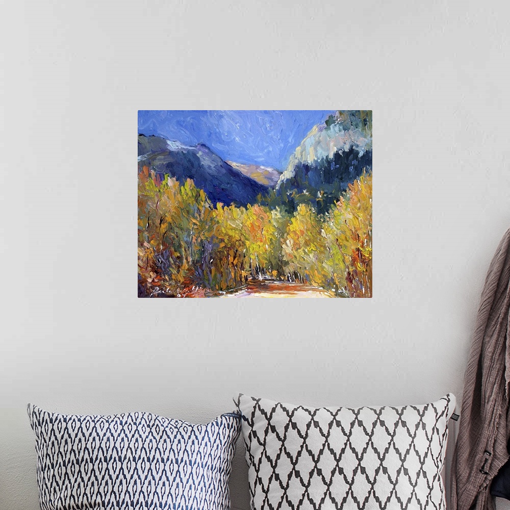 A bohemian room featuring Painting of an idyllic wilderness scene in autumn foliage.