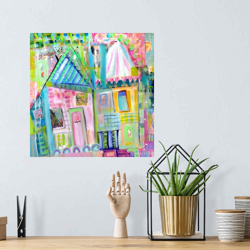 A bohemian room featuring Two pastel colored houses in shades of green, pink, and blue.