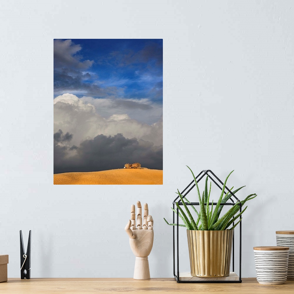 A bohemian room featuring Golden wheat field, house and storm clouds