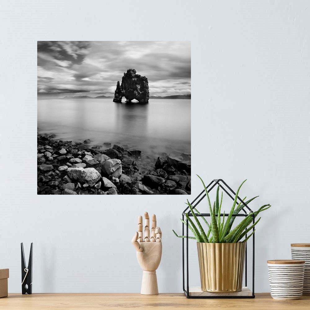 A bohemian room featuring Iceland Dinosaur, rocks out in the water, black and white photography