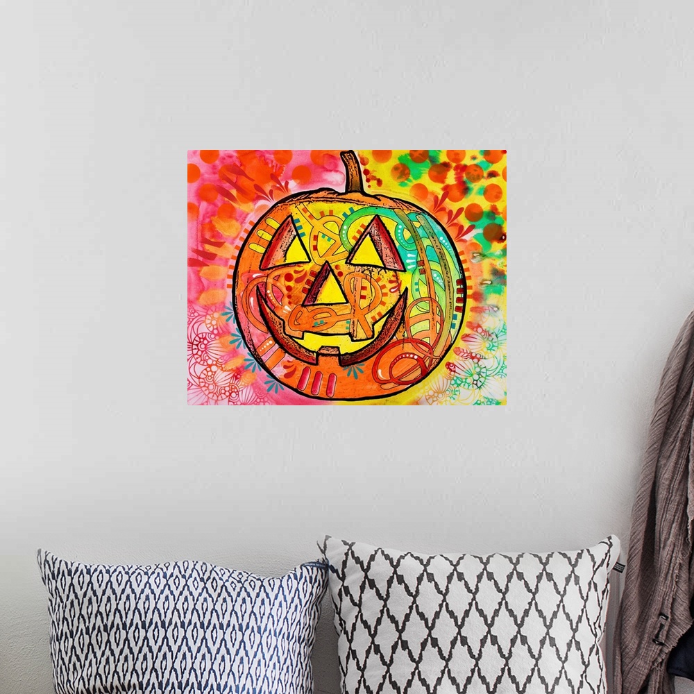 A bohemian room featuring Brightly colored painting of a jack o lantern surrounded by abstract designs.