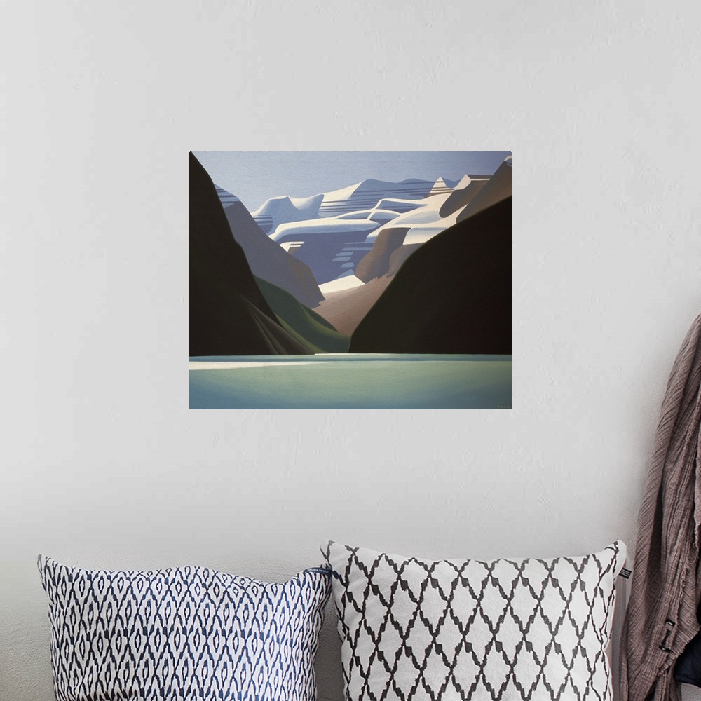 A bohemian room featuring Water in foreground with snow capped mountains rising up behind.