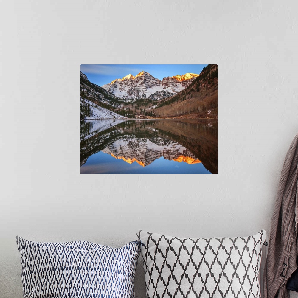 A bohemian room featuring Sunlight on the peaks of the Maroon Bells, reflected in the lake below.