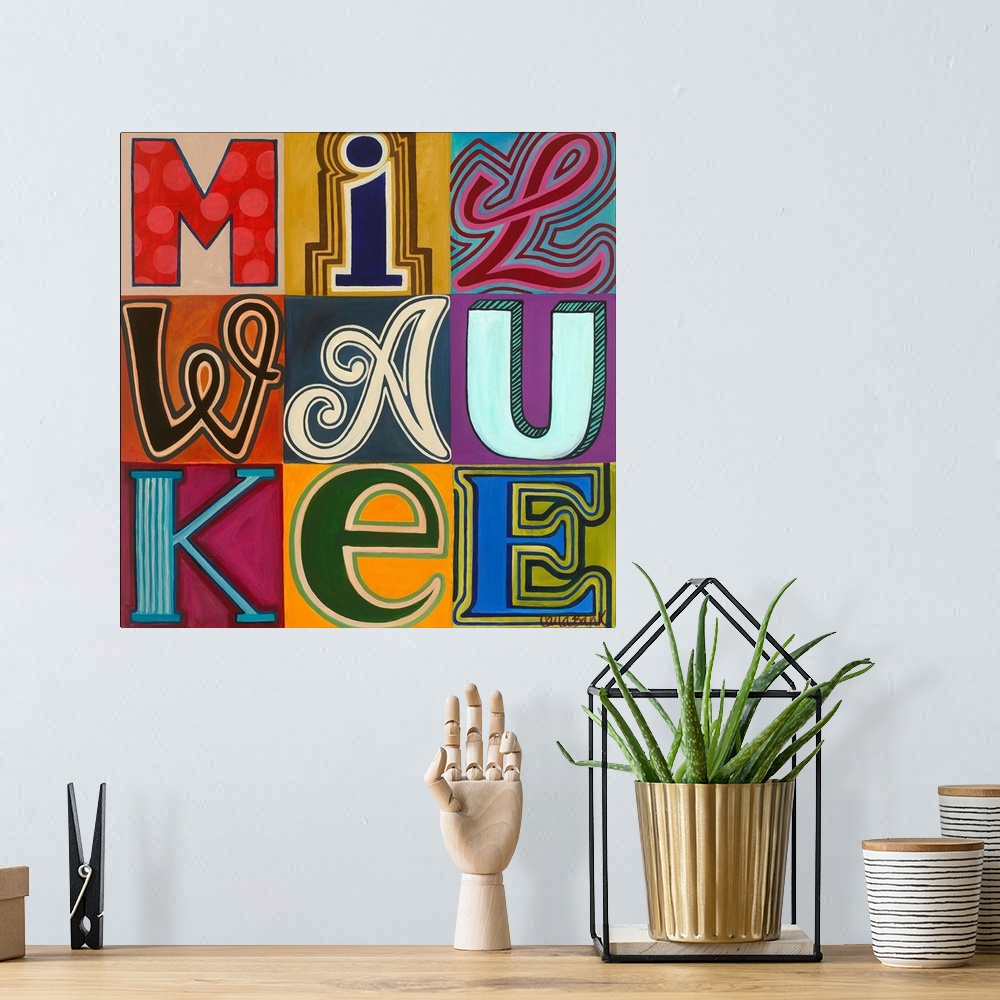 A bohemian room featuring Contemporary typography painting with the word Milwaukee spelled in different fonts.
