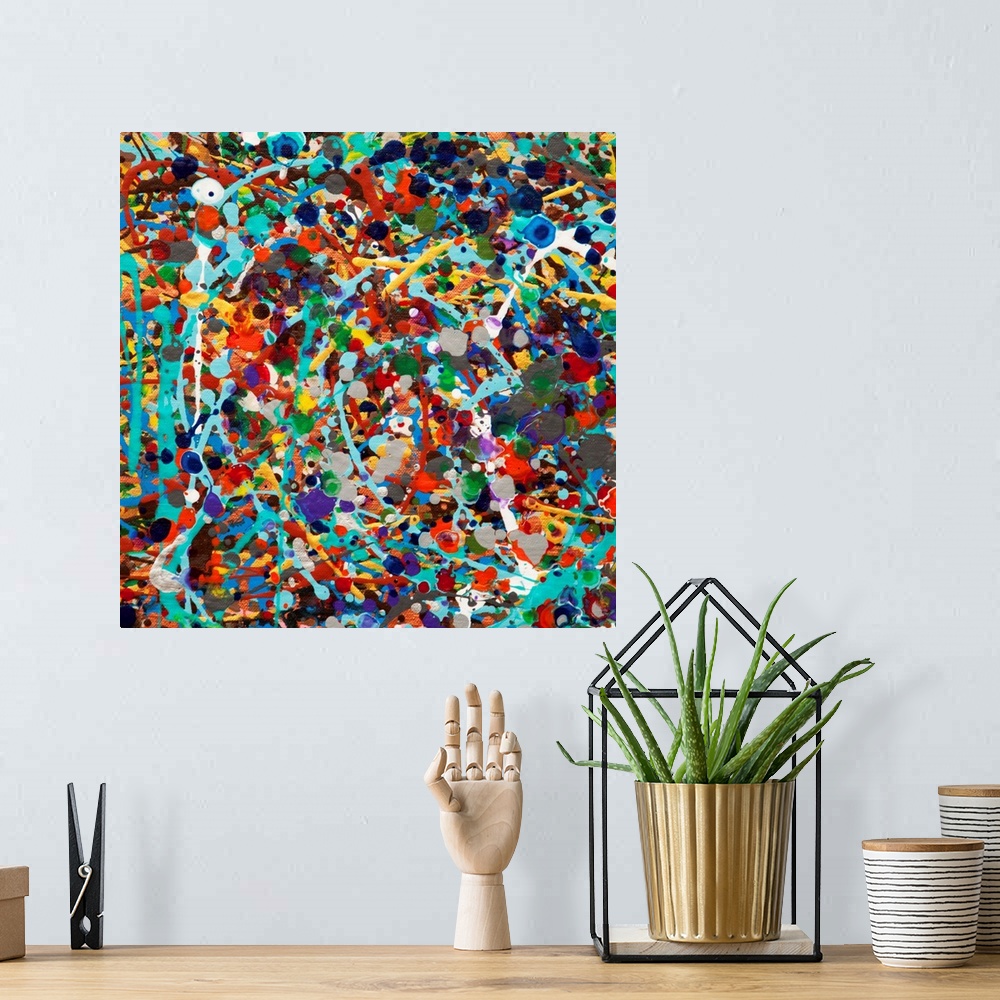 A bohemian room featuring Contemporary abstract painting made of multicolored paint splatters and swirls.