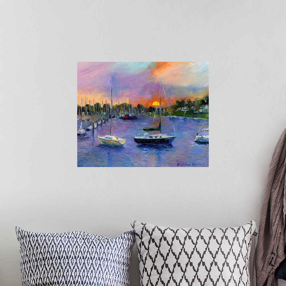 A bohemian room featuring Sail boats in bay with sun setting in background.