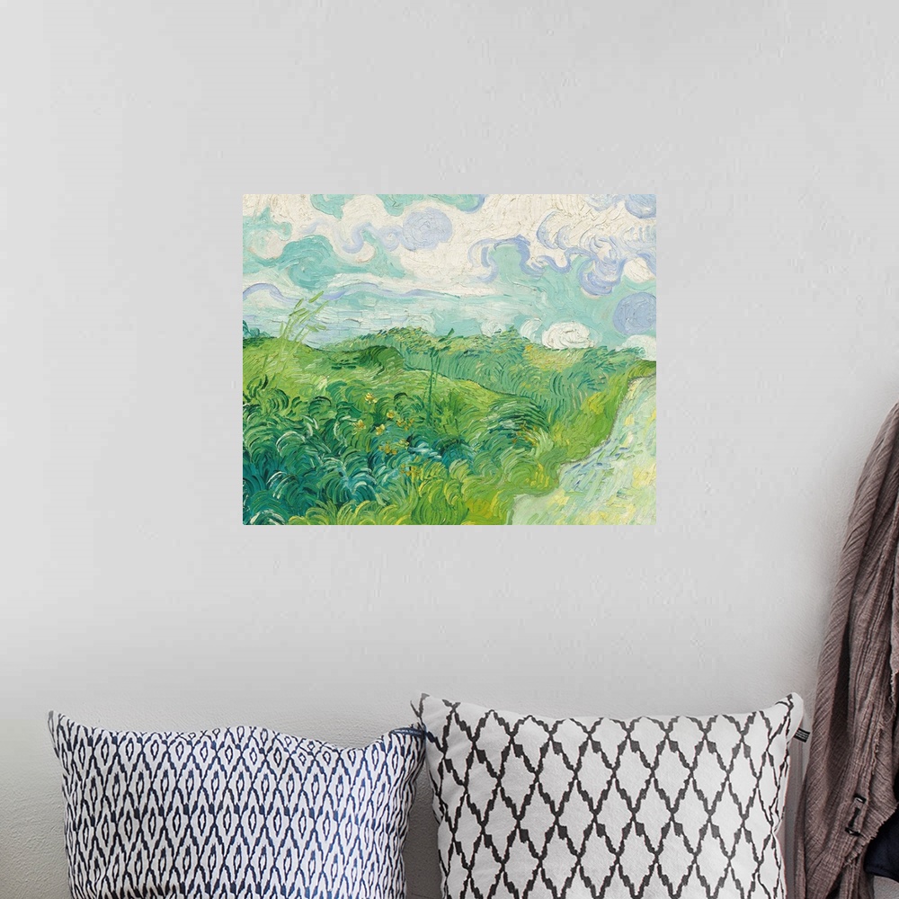 A bohemian room featuring Painting of a green countryside field by Vincent Van Gogh.