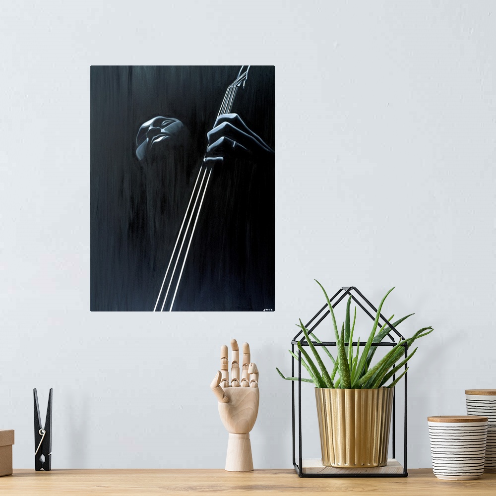 A bohemian room featuring Big contemporary monochromatic art focuses on a close-up of a man playing the bass against a slig...