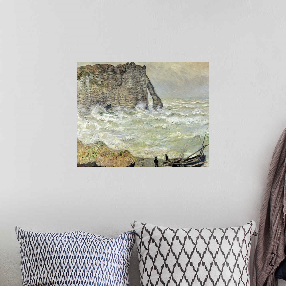 A bohemian room featuring A painting by Claude Monet of two men standing by beached boats as rough waves pound the beach an...