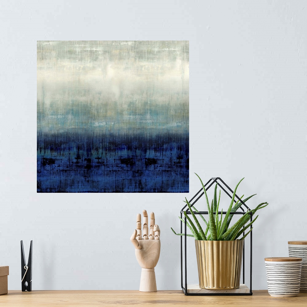 A bohemian room featuring Square abstract painting in shades of blue, gray, and white.