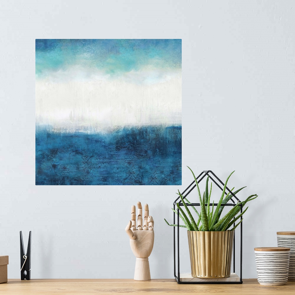 A bohemian room featuring Square abstract painting made with shades of blue and white.