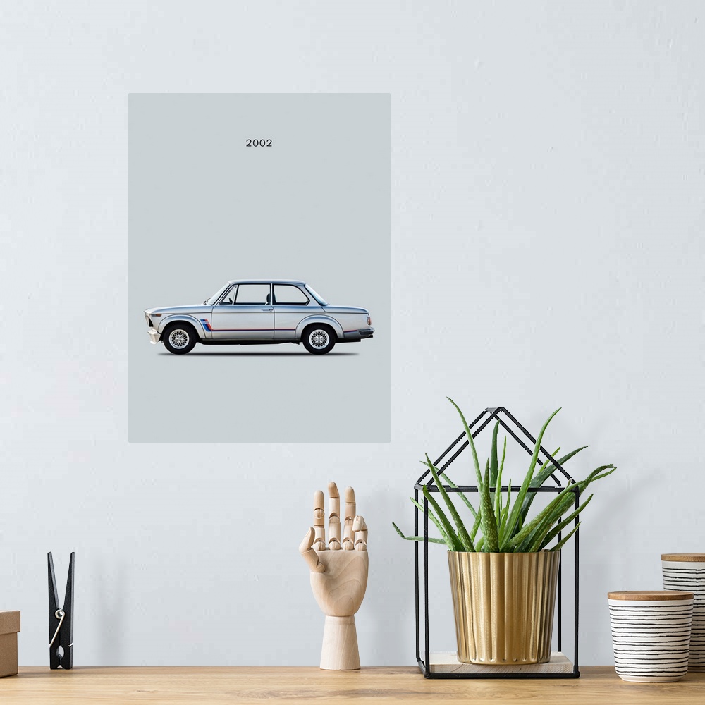 A bohemian room featuring Photograph of a silver BMW 2002 Turbo printed on a gray background