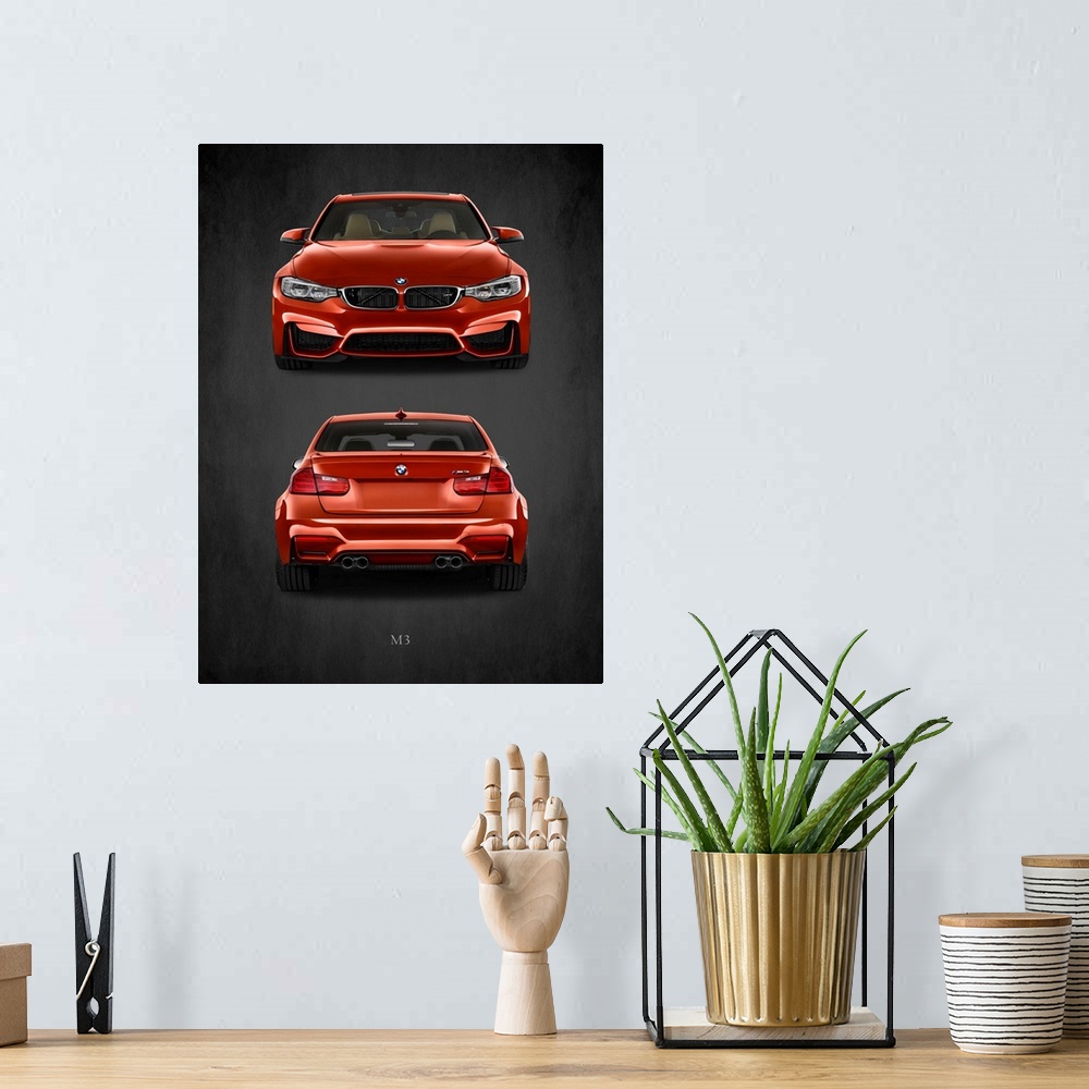 A bohemian room featuring Photograph of the front and back of an orange-red BMW M3 printed on a black background with a dar...