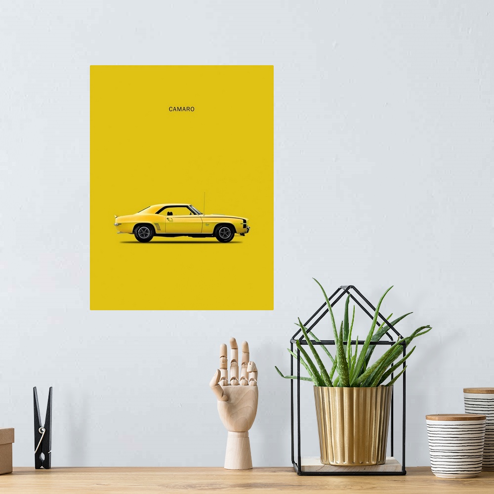 A bohemian room featuring Photograph of a yellow Chev Camaro 1969 printed on a yellow background