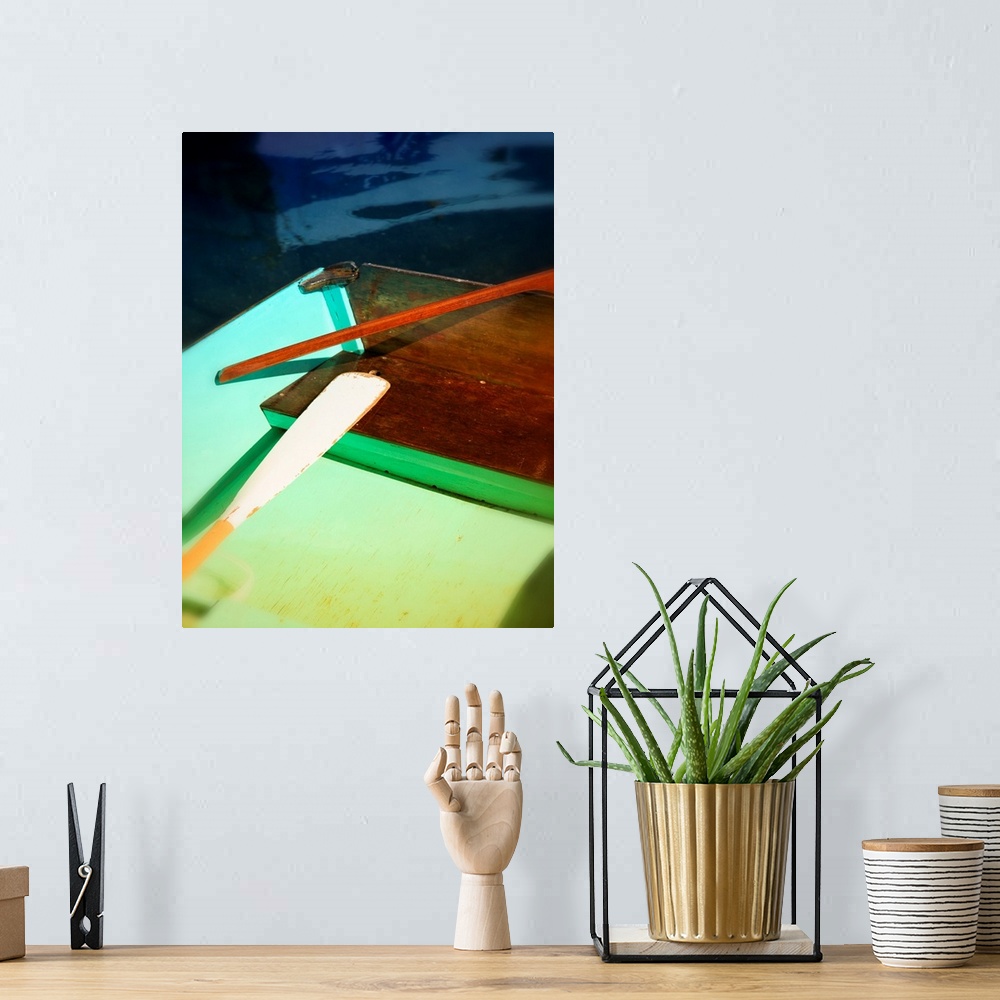 A bohemian room featuring Photograph of a colorful boat and an oar with an interesting composition.