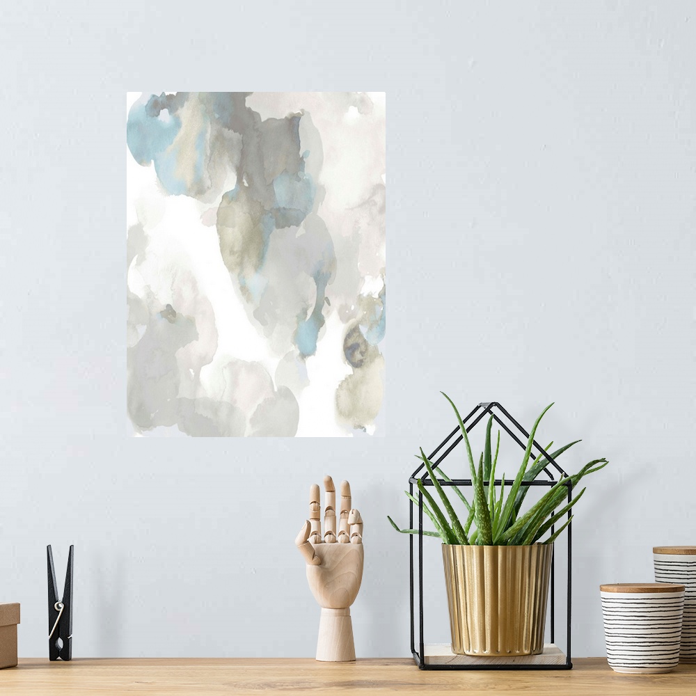 A bohemian room featuring Abstract painting with light blue and gray hues splattered together on a white background.