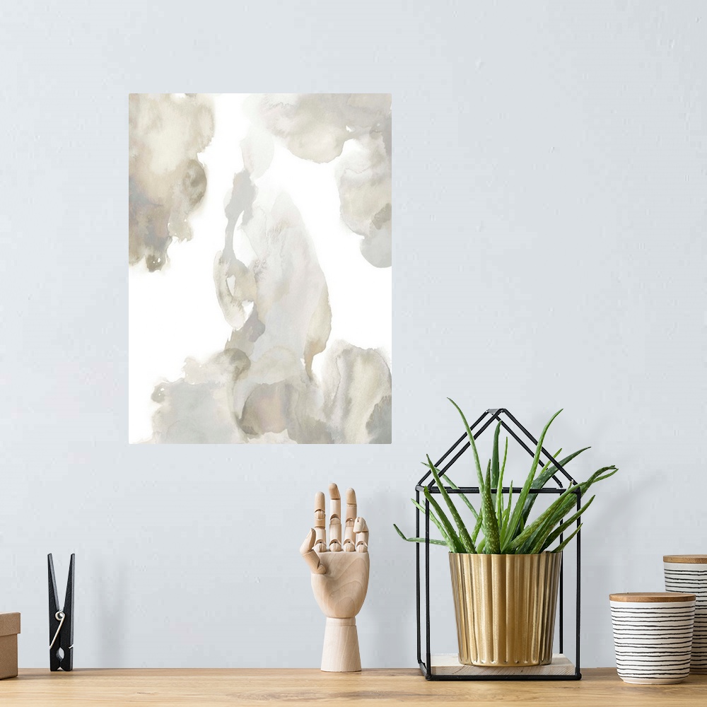 A bohemian room featuring Abstract painting with tan and gray hues splattered together on a white background.