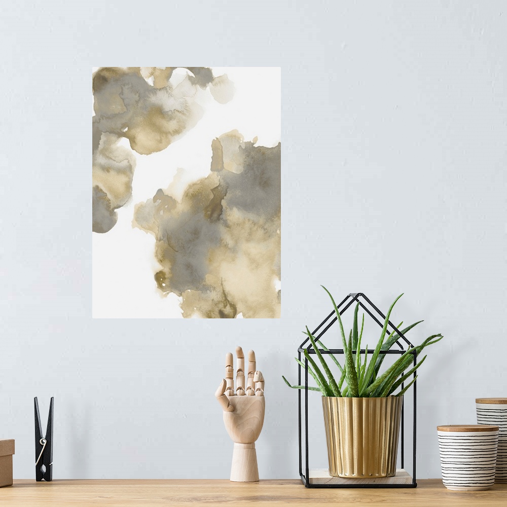 A bohemian room featuring Abstract painting with gold and gray hues splattered together on a white background.