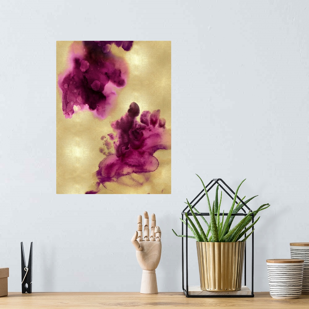 A bohemian room featuring Abstract painting with fuchsia hues splattered together on a gold background.