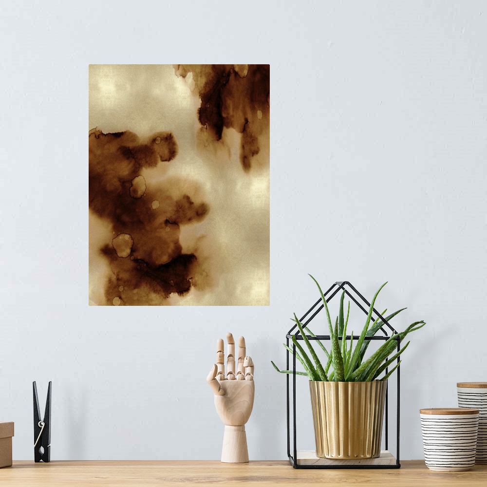 A bohemian room featuring Abstract painting with bronze hues splattered together on a gold background.