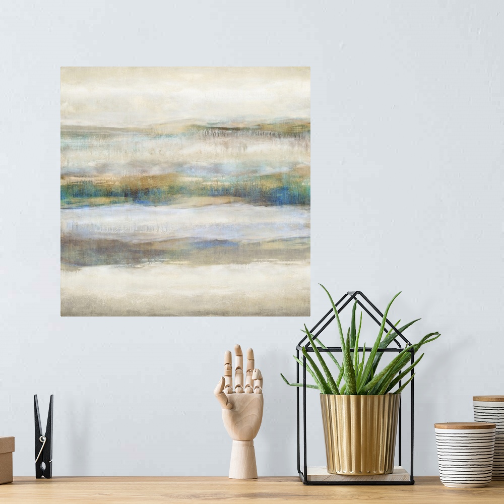 A bohemian room featuring Square abstract painting with neutral colors and pops of blue and gold running horizontally acros...