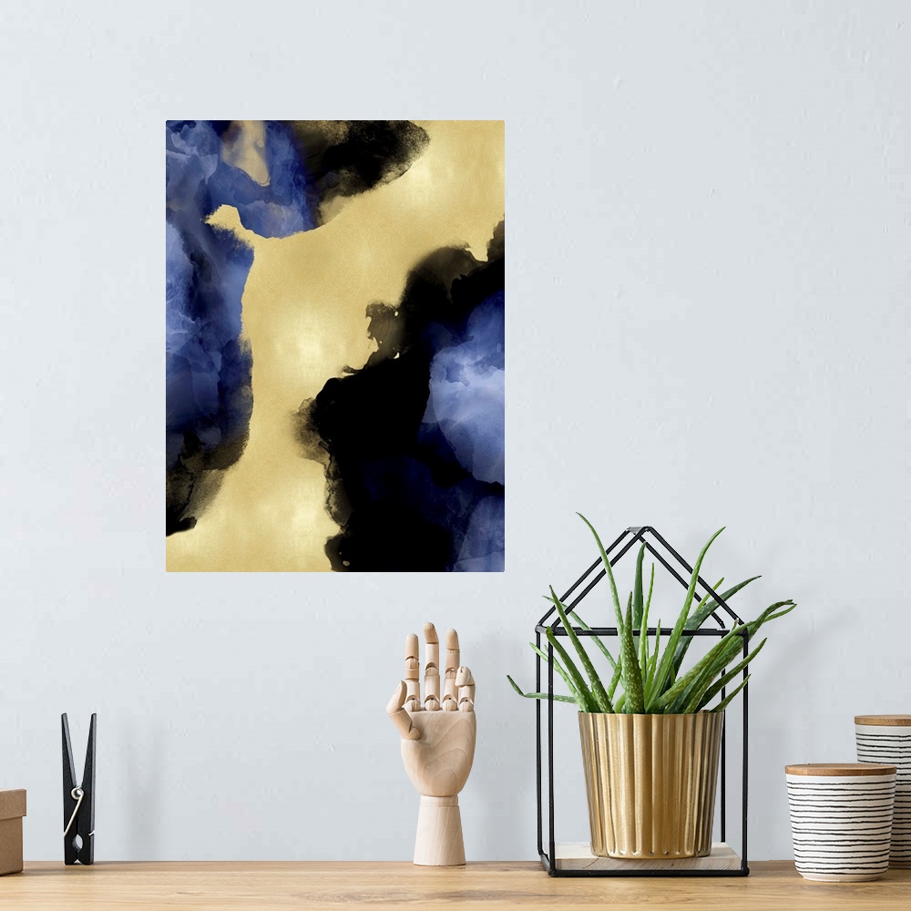 A bohemian room featuring Abstract painting with indigo hues splattered together on a gold background.