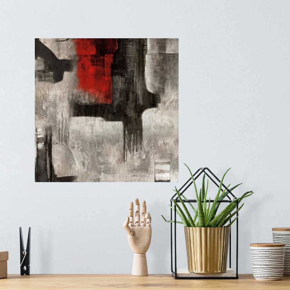 A bohemian room featuring Square abstract painting with bold black and red brushstrokes on top of a white and gray background.