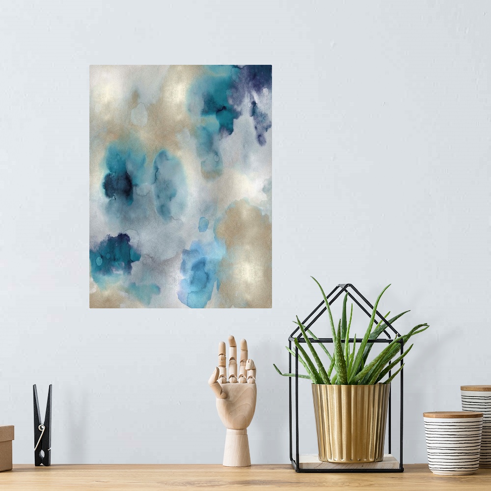 A bohemian room featuring Abstract painting with shades of blue and gold hues splattered together on a silver background.