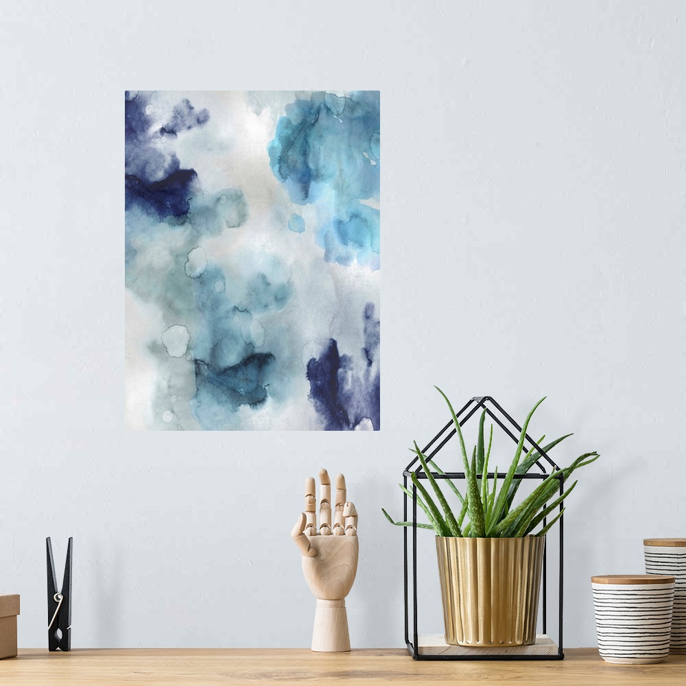 A bohemian room featuring Abstract painting with shades of blue hues splattered together on a silver background.
