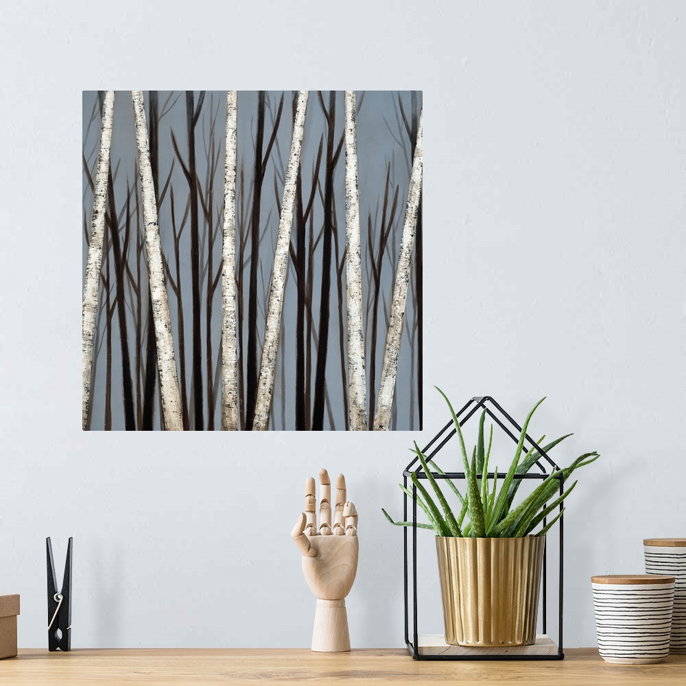 A bohemian room featuring A square painting of a forest of birch trees with shadows of darker trees in the background.