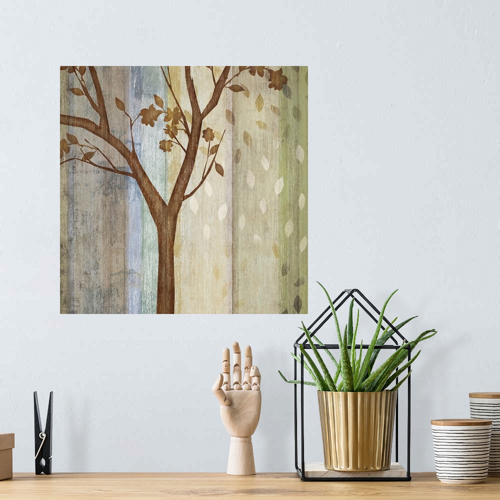 A bohemian room featuring Decorative artwork of a single tree with falling leaves and a color striped background in neutral...